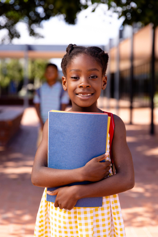 A pupil carrying her folder across the courtyard