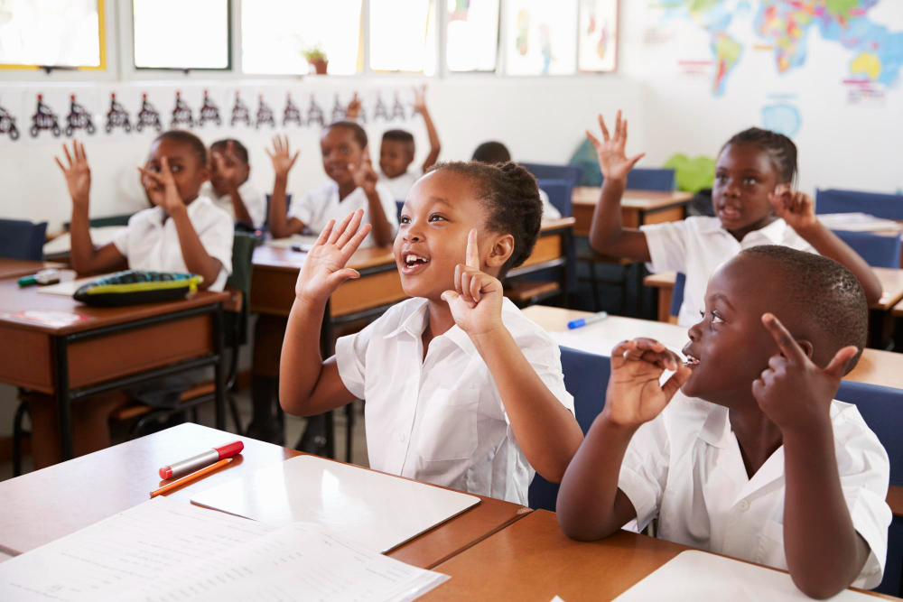 Greenfield pupils raising their hands to answer a question in class